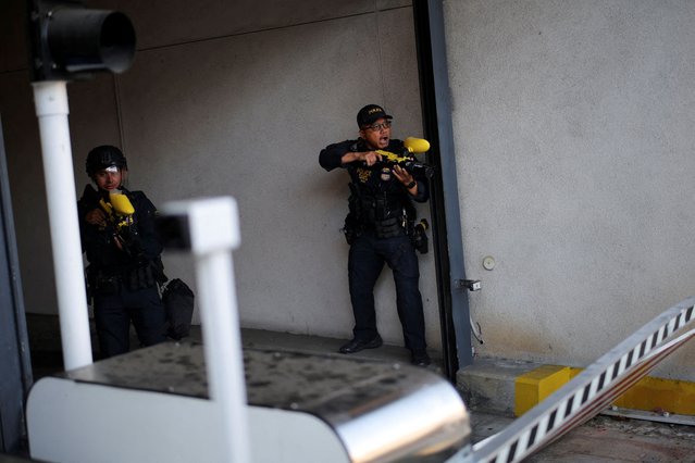 Police fire pepper spray balls at protesters blocking the garage entrance of the Los Angeles Federal Building following multiple detentions by Immigration and Customs Enforcement (ICE), in downtown Los Angeles, California, U.S., June 6, 2025. (Photo by Daniel Cole/Reuters)