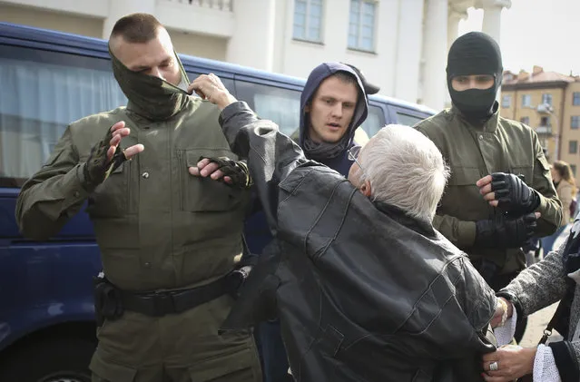 An elderly woman rips the mask off a police officer during an opposition rally to protest the official presidential election results in Minsk, Belarus, Saturday, September 12, 2020. (Photo by Tut.by via AP Photo)