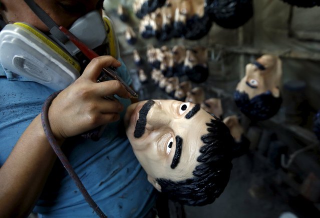 A employee sprays Guzman masks at Grupo Rev in the Mexican city of Cuernavaca near Mexico City October 14, 2015. (Photo by Henry Romero/Reuters)