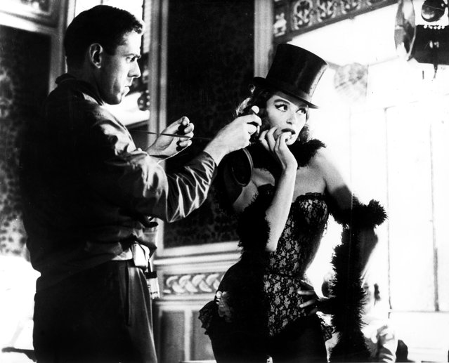 French film actress Anouk Aimée in her signature role of a showgirl in Jacques Demy’s film Lola (1961), seen here with cinematographer Raoul Coutard. (Photo by Ronald Grant/The Guardian)