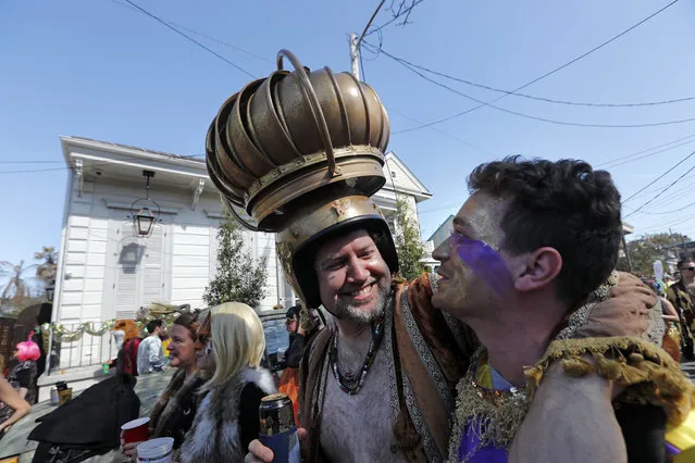 A man uses an attic vent as headgear during the Society de Sainte Anne parade, on Mardi Gras day in New Orleans, Tuesday, February 13, 2018. (Photo by Gerald Herbert/AP Photo)