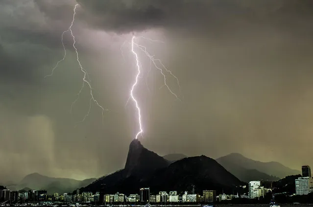 Lightning illuminates the evening sky during rainfall in Rio de Janeiro, Brazil on August 30, 2022. The city of Rio de Janeiro has entered a stage of mobilization because of a cold front, with the forecast of rain throughout the day. There is a forecast of moderate gusts of winds of up to 60 km/h over the coast and the Navy issued a hangover alert with waves up to 3 meters high. (Photo by Fabio Teixeira/Anadolu Agency via Getty Images)