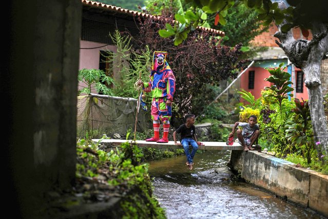 A man dressed as a Dancing Devil of Chuao stands for a picture during the second day of the Corpus Christi celebration in Chuao, Venezuela, on June 19, 2025. The Venezuelan Dancing Devils of Corpus Christi were recognized by UNESCO as Intangible Cultural Heritage in 2012. (Photo by Juan Barreto/AFP Photo)