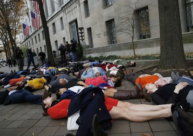 Protestors stage a “die-in” as they rally against the Ferguson, Mo. Grand Jury exoneration of police officer Darren Wilson for his August 2014 shooting and killing of Michael Brown while, at the U.S. Justice Department in Washington, December 1, 2014. (Photo by Larry Downing/Reuters)