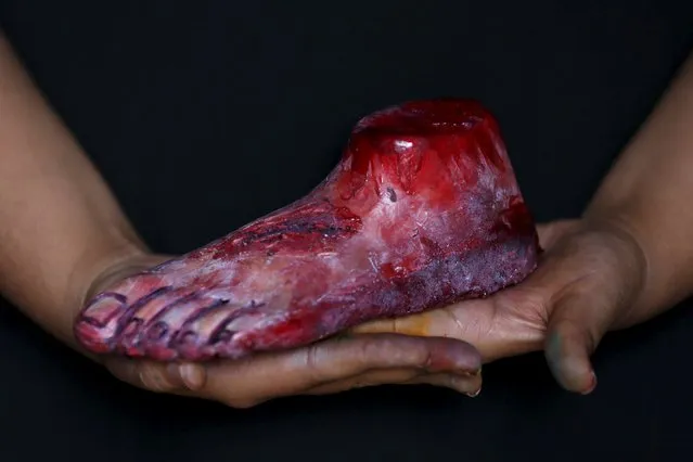 A bloody zombie foot made of gummy candy and red jelly is pictured at the Zombie Gourmet homemade candy manufacturer on the outskirts of Mexico City October 30, 2015. (Photo by Carlos Jasso/Reuters)