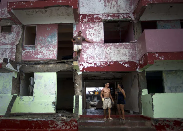 A man looks from the balcony of his house damaged by Hurricane Matthew in Baracoa, Cuba, Wednesday, October 5, 2016. The hurricane rolled across the sparsely populated tip of Cuba overnight, destroying dozens of homes in Cuba's easternmost city, Baracoa, leaving hundreds of others damaged. (Photo by Ramon Espinosa/AP Photo)