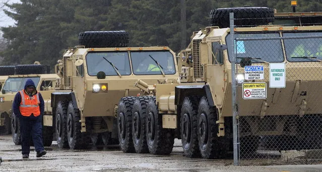 A pair of military vehicles made by Oshkosh Corp. gets ready to head out on a test drive Thursday, April 11, 2013 in Oshkosh, Wis. Faced with deep cuts in U.S. military spending, and the end of the wars in Iraq and Afghanistan, Oshkosh Corp. is laying off 900 employees in its defense division based in Oshkosh. Approximately 700 hourly workers at the state's largest manufacturer will lose their jobs in mid-June, followed by approximately 200 salaried employees through July. (Photo by Mark Hoffman via The Journal Sentinel)