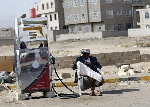 A black market petrol vendor waits for customers on a street during an ongoing fuel crisis that has been continuing for several months now, in Yemen's capital Sanaa November 4, 2015. (Photo by Khaled Abdullah/Reuters)