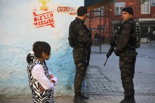 Members of the Turkish police special forces stand guard near a polling station during the parliamentary electin in Diyarbakir, Turkey, in this November 1, 2015 file photo. Tired of trenches in the streets and daily gun battles, shopkeeper Berzani Akdogan is hoping the return of single-party rule might bring stability to Turkey's southeast, even though a heavier military crackdown looks likely in the short term. (Photo by Sertac Kayar/Reuters)