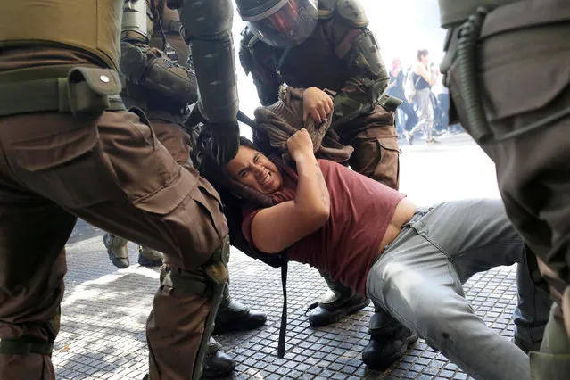 A demonstrator is detained by riot police during a protest demanding an end to profiteering in the education system in Santiago, Chile  April 19, 2018. (Photo by Pablo Sanhueza/Reuters)