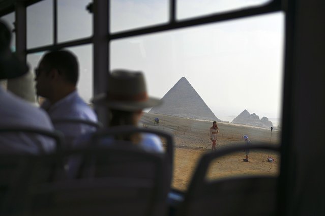 Tourists visit the Giza Plateau, home to the Great Pyramids of Giza and the Sphinx, in Giza, Egypt, 30 October 2025, two days before the opening ceremony of the Grand Egyptian Museum on 01 November 2025. (Photo by Mohamed Hossam/EPA)