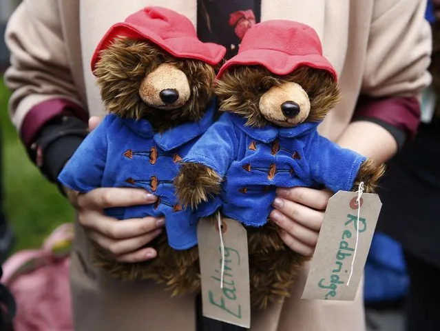 A demonstrator holds Paddington Bear soft toys during a protest highlighting the plight of child refugees, outside the Home Office in London, Britain October 24, 2016. (Photo by Peter Nicholls/Reuters)