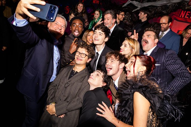 (L-R) Cast and crew, such as Ted Sarandos, Co-CEO, Netflix, Caleb McLaughlin, Priah Ferguson, Joe Chrest, Dan Cohen, Gaten Matarazzo, Noah Schnapp, Natalia Dyer, Charlie Heaton, Finn Wolfhard, David Harbour, Brett Gelman, Millie Bobby Brown, and Jamie Campbell Bower attend Netflix's “Stranger Things” Season 5 World Premiere at TCL Chinese 6 Theatres on November 06, 2025, in Hollywood, California. (Photo by Roger Kisby/Getty Images for Netflix)