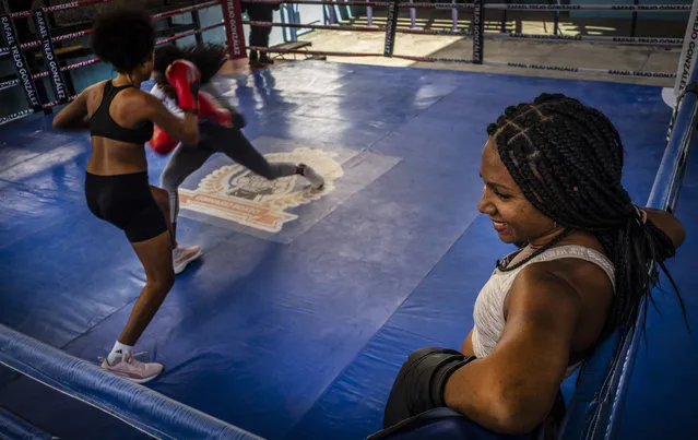Ydamelys Moreno, right, watches as fellow female boxers train in Havana, Cuba, Monday, December 5, 2022. (Photo by Ramon Espinosa/AP Photo)