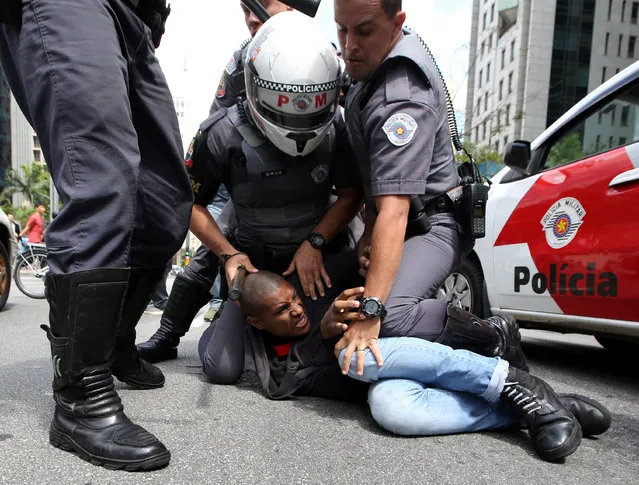 A demonstrator is detained  by police after he clashes with supporters of U.S. Republican presidential nominee Donald Trump at Paulista avenue in Sao Paulo, Brazil, October 29, 2016. (Photo by Paulo Whitaker/Reuters)