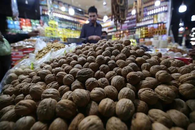 A man sells dry fruits at his shop in Karachi, Pakistan, 16 December 2020. After a good raining season, the sales of dry fruits flourish i​n the country. (Photo by Shahzaib Akber/EPA/EFE)