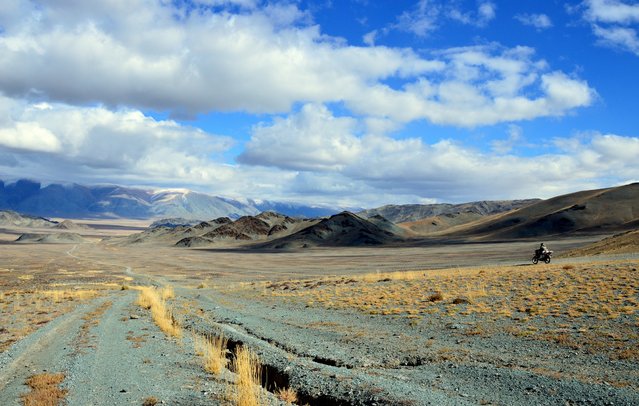 Mongolian vista with motorcycle. (Photo by Brad Ruoho/The Star Tribune)