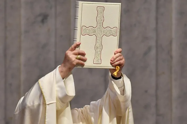 Pope Francis holds the Book of Prayers during a Holy Mass on the Solemnity of the Most Holy Body and Blood of Christ, on June 14, 2020 at St. Peter's Basilica in The Vatican, as the city-state eases its lockdown aimed at curbing the spread of the COVID-19 infection, caused by the novel coronavirus. (Photo by Tiziana Fabi/AFP Photo)