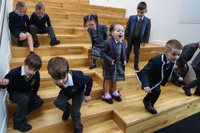 Evie McGowan reacts as she joins other twins about to start primary schools in the Inverclyde area at a photocall at St Patrick's school on August 13, 2024 in Greenock, Scotland. The new starters joining St. Patrick's Primary in Greenock this year are part of a local phenomenon tied to Inverclyde's high twin birthrate, which has earned the Scottish council the nickname “Twinverclyde”. Since 2013, 147 pairs have begun their schooling in the region, averaging 13 per year. (Photo by Jeff J. Mitchell/Getty Images)