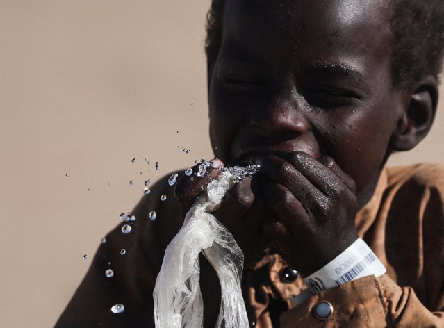 A Sudanese refugee boy from al-Fashir drinks water at the Tine transit refugee camp, amid the conflict between the paramilitary Rapid Support Forces (RSF) and the Sudanese army, in eastern Chad, on November 23, 2025. (Photo by Amr Abdallah Dalsh/Reuters)