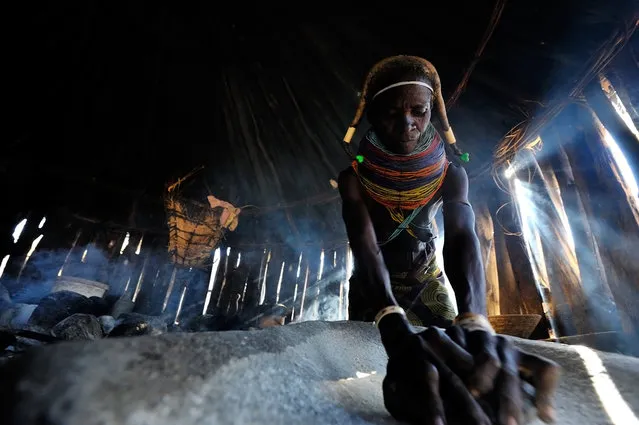 “Making dinner”. This photo was made in a small muila village in South-Angola, Africa, 2012 June. The spontaneous moment was captured inside of the hut of the lady. (Photo and caption by Gergely Lantai-Csont/National Geographic Traveler Photo Contest)