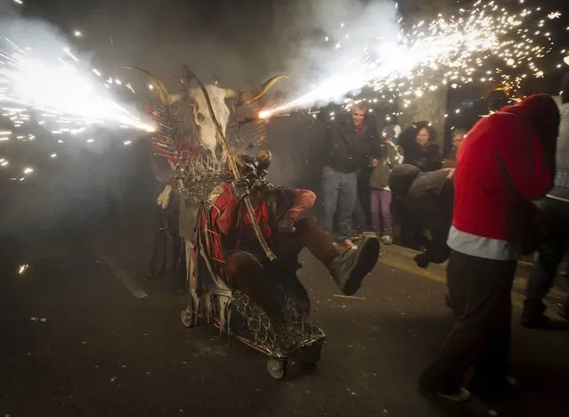 A reveller wearing a demon costume takes part in the traditional festival of “Correfoc” in Palma de Mallorca, on January 17, 2015. (Photo by Jaime Reina/AFP Photo)