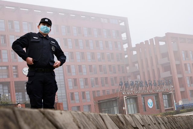 A security member keeps watch outside Wuhan Institute of Virology during the visit by the WHO team in Wuhan, China, February 3, 2021. A team of investigators led by the WHO is visiting the Chinese city in its search for clues to the origins of the COVID-19 pandemic. (Photo by Thomas Peter/Reuters)