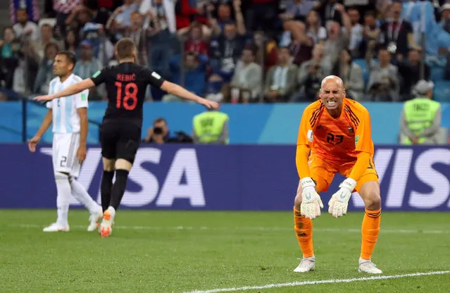Argentina goalkeeper Wilfredo Caballero holds his head after Croatia's Ante Rebic, background right, scored the opening goal during the group D match between Argentina and Croatia at the 2018 soccer World Cup in Nizhny Novgorod Stadium in Nizhny Novgorod, Russia, Thursday, June 21, 2018. (Photo by Ivan Alvarado/Reuters)
