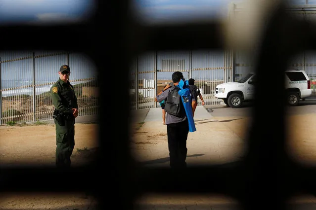 People in Friendship Park in San Diego, California, U.S. are seen behind a fence separating Mexico and the United States, November 12, 2016. Picture taken from Tijuana, Mexico. (Photo by Jorge Duenes/Reuters)