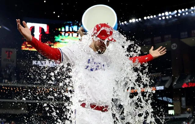 Texas Rangers starting pitcher Dane Dunning, right, get doused by Martin Perez after the team's baseball game against the Detroit Tigers in Arlington, Texas, Wednesday, June 28, 2023. (Photo by USA TODAY Sports via Reuters)