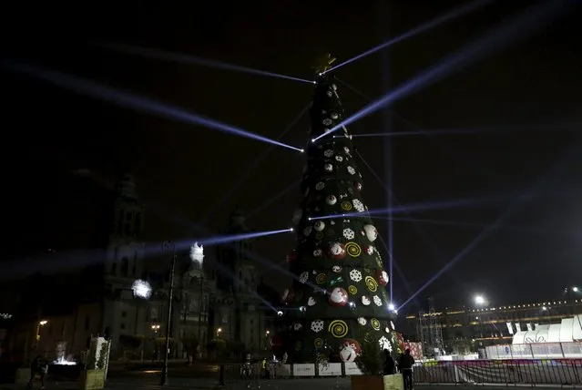 A Christmas tree stands in front of the Palacio Nacional in Zocalo Square, downtown Mexico City, Mexico, December 10, 2015. (Photo by Henry Romero/Reuters)