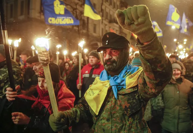 Supporters of different nationalist parties carry torches during their march to mark the 107th anniversary of Stepan Bandera birth in Kiev, Ukraine, 01 January 2016. Stepan Bandera was a Ukrainian politician and one of the leaders of Ukrainian national movement in occupied Western Ukraine (Galicia), who headed the Organization of Ukrainian Nationalists (OUN). He was responsible for the proclamation of an Independent Ukrainian State in Lviv on 30 June 1941. Allegedly, Soviet authorities authorized the KGB to assassinate him which took place in Munich, West Germany, on 15 October 1959. (Photo by Sergey Dolzhenko/EPA)