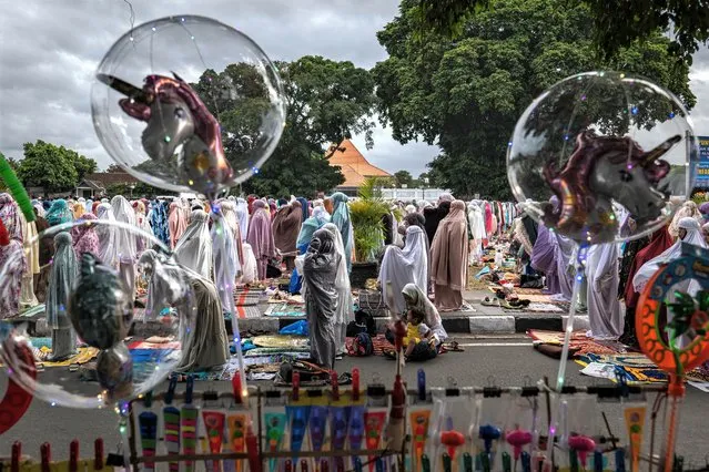 Indonesian Muslims perform Eid al-Adha prayer at southern city square, known as “Alun-alun kidul”, on June 28, 2023 in Yogyakarta, Indonesia. Muslims worldwide celebrate Eid Al-Adha to commemorate the Prophet Ibrahim's readiness to sacrifice his son as a sign of his obedience to God, during which they sacrifice permissible animals, generally goats, sheep, and cows. (Photo by Ulet Ifansasti/Getty Images)