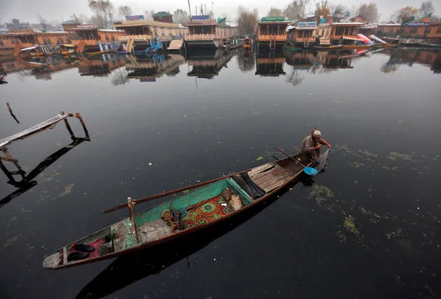 A man fishes in the waters of the Dal Lake in Srinagar, November 28, 2016. (Photo by Danish Ismail/Reuters)