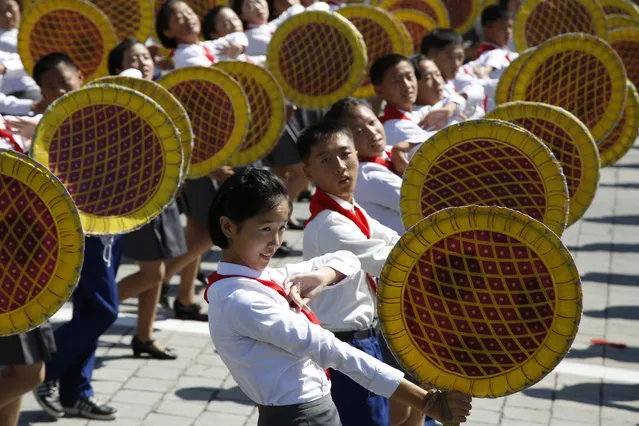 A girl reacts during a parade marking the 70th anniversary of North Korea's founding day in Pyongyang, North Korea, on September 9, 2018. (Photo by Ng Han Guan/AP Photo)