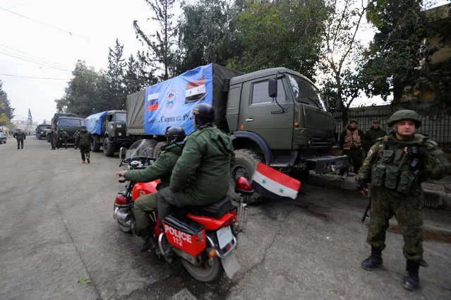 Russian soldiers stand near their vehicles in Aleppo, Syria December 4, 2016. (Photo by Omar Sanadiki/Reuters)