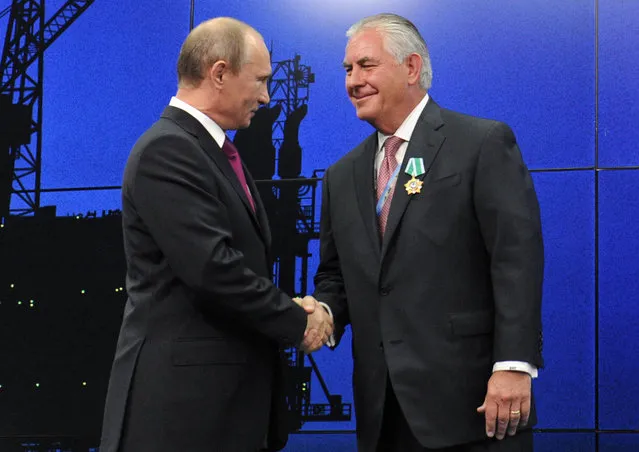 In this photo taken Thursday, June 21, 2012, Russian President Vladimir Putin presents ExxonMobil CEO Rex Tillerson with a Russian medal at an award ceremony of heads and employees of energy companies at the St. Petersburg economic forum in St. Petersburg, Russia. An aide to President Vladimir Putin praised United States President-elect Donald Trump’s choice of Rex Tillerson to lead the State Department and says that the businessman is well regarded by many Russian officials. ﻿(Photo by Mikhail Klimentyev/Sputnik/Kremlin Pool Photo via AP Photo)