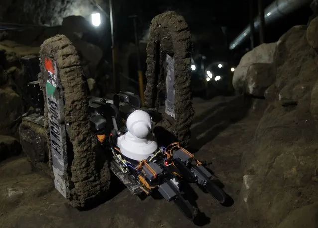 A robot used to explore ruins is seen on the entrance of a tunnel in the archaeological area of the Quetzalcoatl Temple near the Pyramid of the Sun at the Teotihuacan archaeological site, about 60 km (37 miles) north of Mexico City April 22, 2013.A robot has discovered three ancient chambers at the last stretch of unexplored tunnel at Mexico's famed Teotihuacan archaeological site on Monday, the first robotic discovery of its kind in the Latin American country. Named Tlaloc II after the Aztec god of rain, the robot was first lowered into the depths of the 2,000-year-old tunnel under the Quetzalcoatl Temple to check it was safe for human entry. After months of exploration, the remote-controlled vehicle has relayed back video images to researchers of what appears to be three ancient chambers located under the Mesoamerican city's pyramid. (Photo by Henry Romero/Reuters)