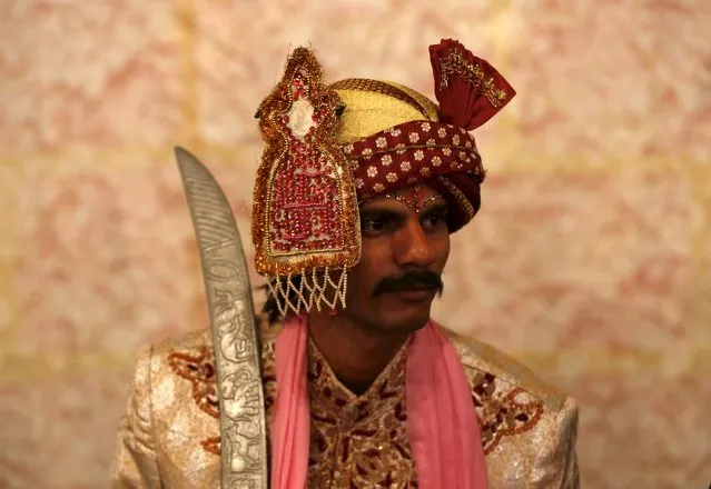 A groom in traditional dress waits for his wedding to start during a mass marriage ceremony in Karachi, Pakistan, January 24, 2016. (Photo by Akhtar Soomro/Reuters)