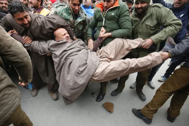 Indian Policemen try to detain a Kashmiri law maker, Abdul Rashid Sheikh during a protest in Srinagar, the summer capital of Indian Kashmir, India, 22 December 2016. Sheikh and nearly a dozen of his supporters were detained by Indian Police as they protested against issuance of domicile certificates to West Pakistan refugees, the Hindus who crossed over from Pakistan and took refugees in Indian Kashmir after 1947, 1965 and 1971 wars between India and Pakistan. (Photo by Farooq Khan/EPA)