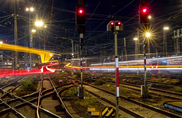 Long exposure photo shows trains approaching and leaving the central train station in Frankfurt, Germany, late Monday, September 25, 2023. (Photo by Michael Probst/AP Photo)