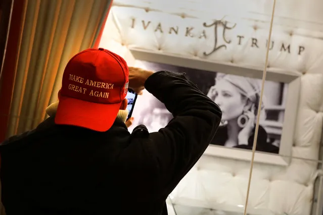 A man wearing a “Make America Great Again” cap takes a picture of Ivanka Trump jewelry display window inside Trump Tower in New York City, U.S. December 17, 2016. (Photo by Kevin Coombs/Reuters)