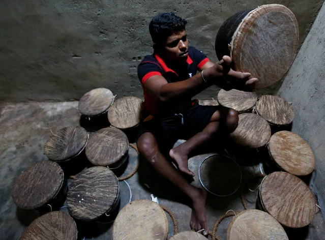 A man inspects damages on traditional drums at a workshop in Nittambuwa, Sri Lanka November 8, 2016. (Photo by Dinuka Liyanawatte/Reuters)