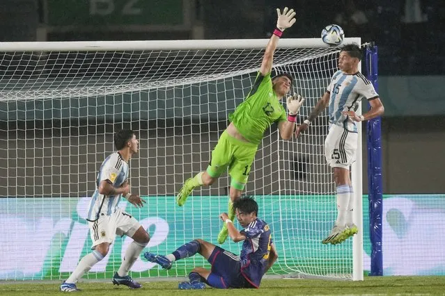 Argentina's Juan Gimenez, right, hits the ball against Japan's goalkeeper Taisei Kambayashi during their FIFA U-17 World Cup Group D soccer match at Si Jalak Harupat Stadium in Bandung, West Java, Indonesia, Tuesday, November 14, 2023. (Photo by Achmad Ibrahim/AP Photo)