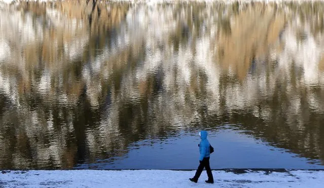 A pedestrian walks along an embankment of the Yenisei River in Divnogorsk town, near the Russian Siberian city of Krasnoyarsk, February 12, 2015. (Photo by Ilya Naymushin/Reuters)