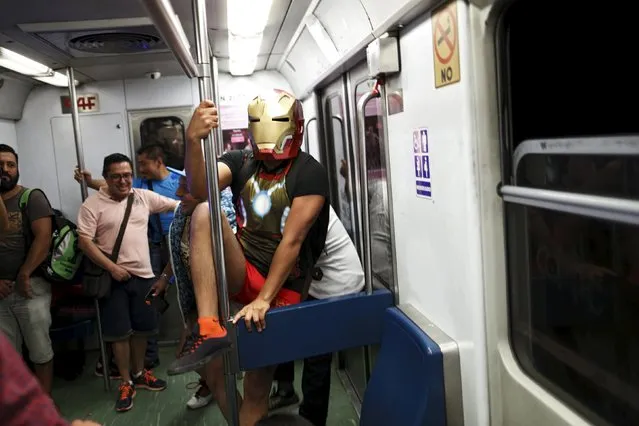 A passenger with a superhero mask plays inside a subway train during the “No Pants Subway Ride” in Mexico City, Mexico, February 21, 2016. (Photo by Carlos Jasso/Reuters)