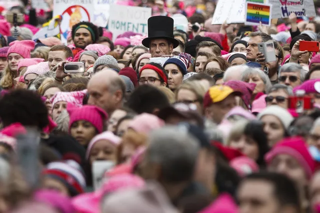 A man dressed as Abraham Lincoln stands with protestors at the Women's March on Washington during the first full day of Donald Trump's presidency, Saturday, January 21, 2017 in Washington. Organizers of the Women's March on Washington expect more than 200,000 people to attend the gathering. Other protests are expected in other U.S. cities. (Photo by John Minchillo/AP Photo)