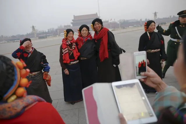 Women wearing traditional clothes take pictures of themselves after a flag-raising ceremony at Tiananmen Square as the area near the Great Hall of the People prepares for upcoming annual sessions of the National People's Congress (NPC) and Chinese People's Political Consultative Conference (CPPCC) in Beijing March 3, 2016. (Photo by Damir Sagolj/Reuters)
