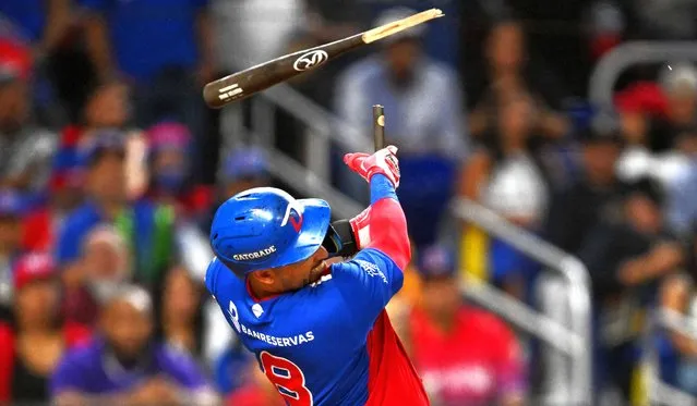 Dominican Republic's catcher #08 Webster Rivas breaks his bat as he hits the ball during the Caribbean Series baseball championship game between the Dominican Republic and Venezuela at LoanDepot Park in Miami, Florida, on February 9, 2024. (Photo by Chandan Khanna/AFP Photo)