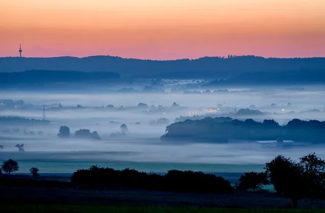 Fog lies over the fields of the Taunus region near Frankfurt, Germany, Wednesday, September 8, 2021. (Photo by Michael Probst/AP Photo)